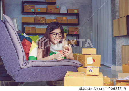Young asian teenager owner business woman work at home for online shopping, checking order and prepaing package the product with office equipment, entrepreneur and alpha generation life style concept Young asian teenager owner business woman work at home for online shopping, checking order and prepaing package the product with office equipment, entrepreneur and alpha generation life style concept 30685249