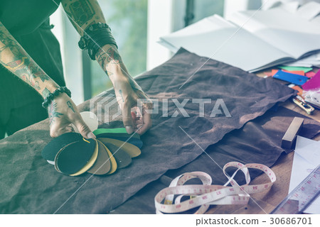 Fashion designer tattooed girl choosing material 30686701