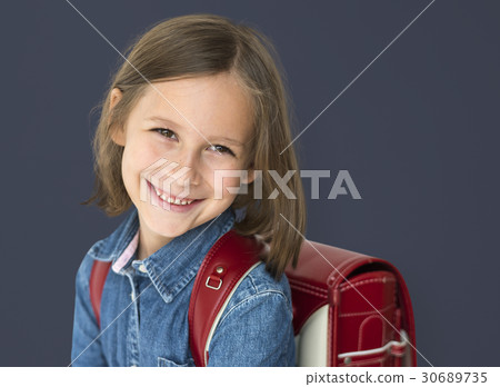 Young girl with a backpack cheerful studio portrait Young girl with a backpack cheerful studio portrait 30689735
