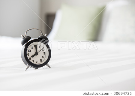 Alarm clock on the bed and time to wake up Alarm clock on the bed and time to wake up 30694725