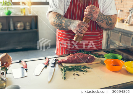 Thick guy peppering meat before cooking Thick guy peppering meat before cooking 30694805