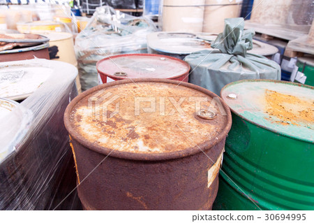 Old, rusty barrels with toxic chemical waste 30694995