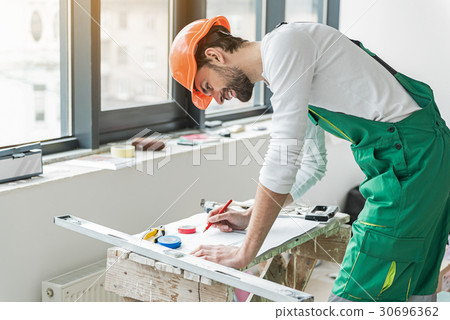 Concentrated smiling builder working on plan Concentrated smiling builder working on plan 30696362