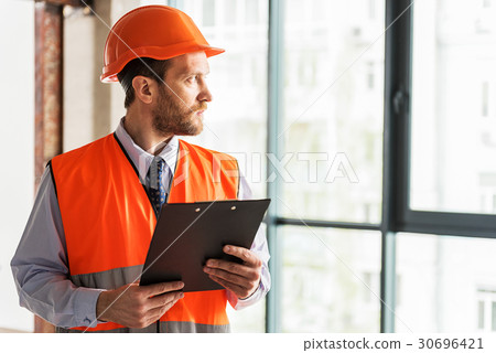 Serious bearded foreman glancing aside 30696421