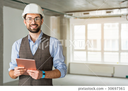 Happy smiling foreman keeping gadget Happy smiling foreman keeping gadget 30697361