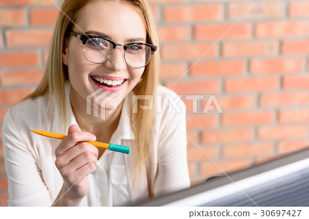 Charming girl looking at camera with happiness Charming girl looking at camera with happiness 30697427
