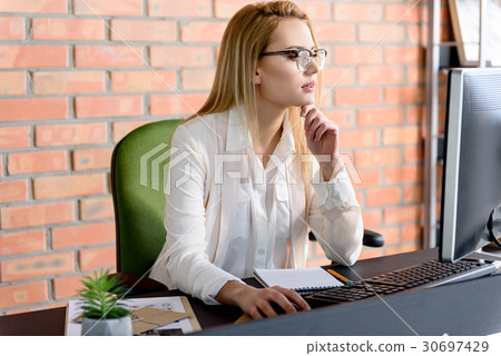 Smart woman busy at her job Smart woman busy at her job 30697429