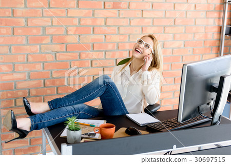 Cheerful girl enjoying her work in office Cheerful girl enjoying her work in office 30697515