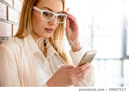 Successful business woman using handset against 30697517