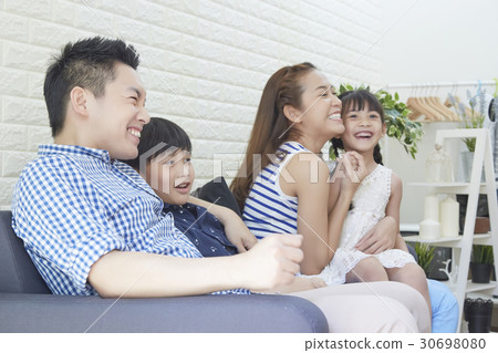 the family of four people is laughing. 30698080