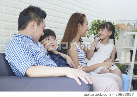 Four members of a family are talking to each other. 30698097