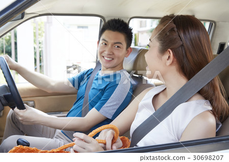 Portrait of a cute couple having fun in a car. Portrait of a cute couple having fun in a car. 30698207