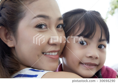 a portrait of a woman and a girl smiling 30698290