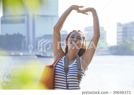 A portrait of a girl smiling and rising her arms up. 30698373