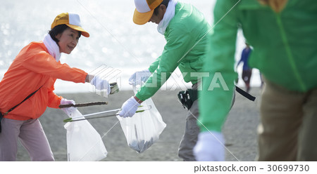 Senior volunteers and surfers to clean the beach Senior volunteers and surfers to clean the beach 30699730