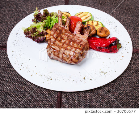 Delicious lamb racks with griled vegetables. Delicious lamb racks with griled vegetables. 30700577