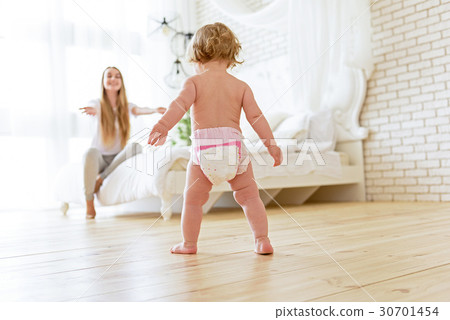 Pretty little girl learning to walk Pretty little girl learning to walk 30701454