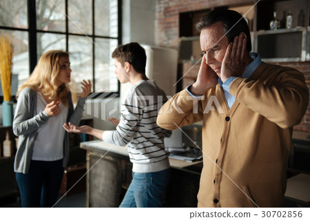 Disappointed male person putting hands on his ears Disappointed male person putting hands on his ears 30702856