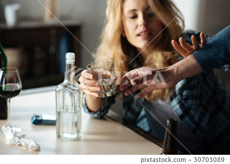 Close up of male hand while taking away glass with Close up of male hand while taking away glass with 30703089