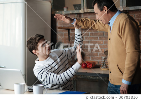 Angry strong teenager catching hand over his head 30703810