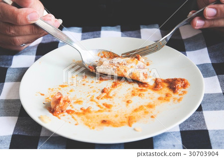 Man eating roti with traditional chicken curry 30703904