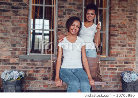 Attractive african american girl in white T-shirts Attractive african american girl in white T-shirts 30703980