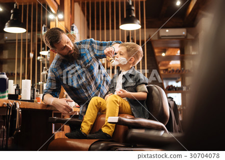 Professional nice barber using a shaving foam Professional nice barber using a shaving foam 30704078