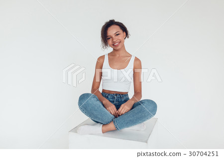 Beautiful african girl in white tops sitting on Beautiful african girl in white tops sitting on 30704251