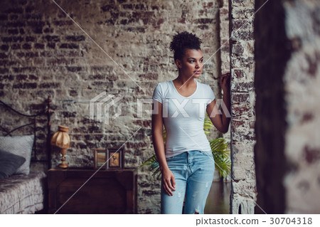 Beautiful african girl in white t-shirt standing 30704318