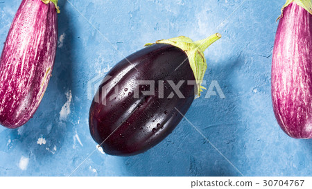 Eggplants on blue textured background 30704767