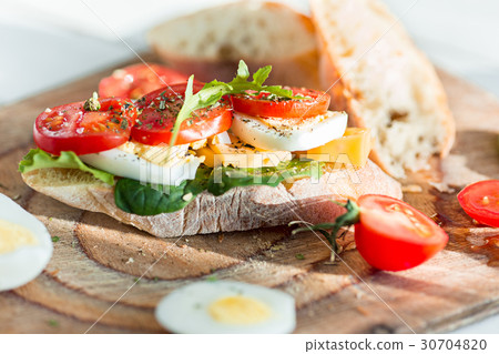 The baguette and cheese on wooden background The baguette and cheese on wooden background 30704820