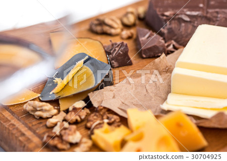 The different kind of cheese and walnuts on wooden 30704925
