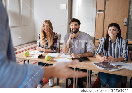 Handsome man sitting between his beautiful 30705031