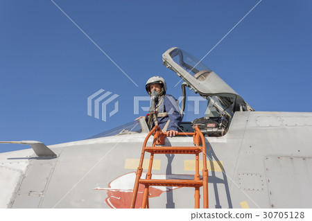 Military pilot in the cockpit of a jet aircraft 30705128