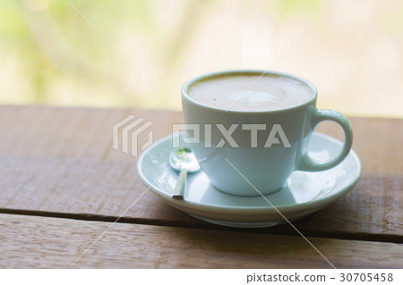 Coffee late on wood table background and garden vi 30705458