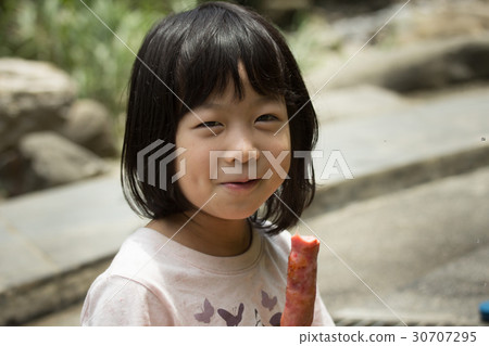 Little girl eating sausage Little girl eating sausage 30707295