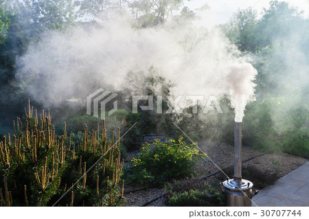 Smoke from a samovar pipe on backyard 30707744