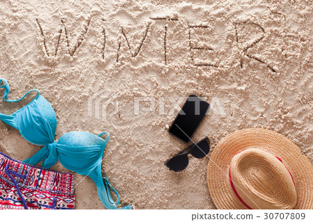 Winter written in a sandy tropical beach 30707809