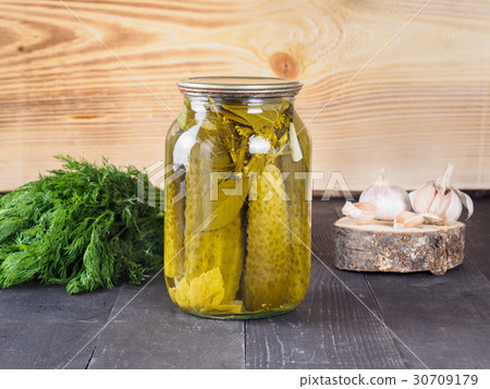 Pickled cucumbers on wooden background 30709179