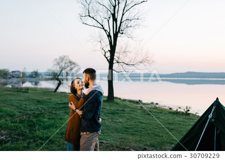Young loving couple on a picnic outdoors Young loving couple on a picnic outdoors 30709229
