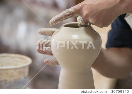 Potter makes pottery handmade in the workshop Potter makes pottery handmade in the workshop 30709540
