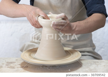Potter makes pottery handmade in the workshop Potter makes pottery handmade in the workshop 30709542