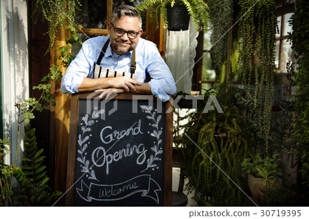 Adult Man Standing with Grand Opening Sign 30719395