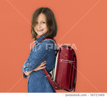 A girl with backpack is smiling. A girl with backpack is smiling. 30721469