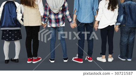 Group of diverse kids students standing in a row holdings hands Group of diverse kids students standing in a row holdings hands 30721587