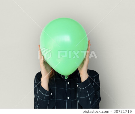 Woman close up holding balloon and posing for photoshoot Woman close up holding balloon and posing for photoshoot 30721719