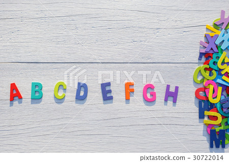 Colorful wooden alphabet. Top view on white wooden 30722014