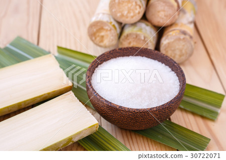 White sugar and sugar cane on wooden table background 30722071