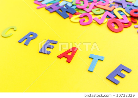 Colorful wooden alphabet and word "CREATE". Top view on yellow table Colorful wooden alphabet and word "CREATE". Top view on yellow table 30722329