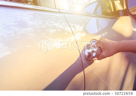 Woman hand opening car door. Shot at evening with lens flare effect Woman hand opening car door. Shot at evening with lens flare effect 30722659